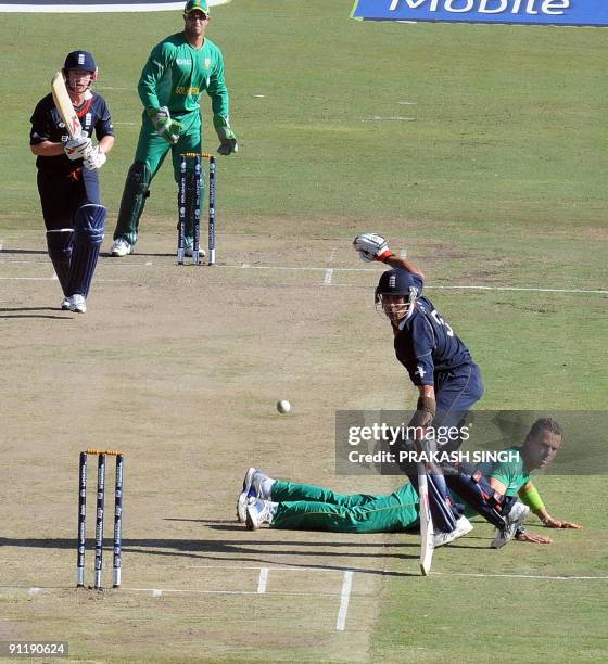 England's batsman Owais Shah watches as South African's bowler Johan Botha makes an unsuccessful attempt to stop a shot by Paul Collingwood during...