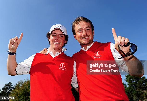 Rory McIlroy and Graeme McDowell of the Great Britain and Northern Ireland team celebrate after winning their matches during the final day singles...