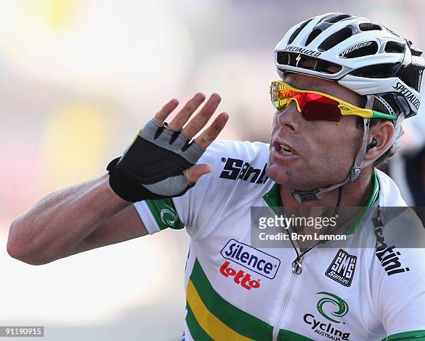 Cadel Evans of Australia waves as he crosses the finish line to win the Men's Road Race at the 2009 UCI Road World Championships on September 27,...