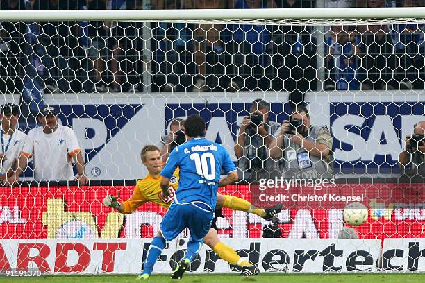 Carlos Eduardo of Hoffenheim scores the fifth goal by penalty against Timo Ochs of Berlin during the Bundesliga match between 1899 Hoffenheim and...