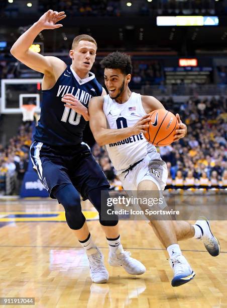 Marquette Golden Eagles guard Markus Howard drives on Villanova Wildcats guard Donte DiVincenzo during the game between the Marquette Golden Eagles...