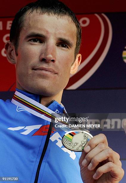 Silver medalist Russia's Alexandr Kolobnev celebrates on the podium of the Elite men's world road race championships at Mendrisio on September 27,...