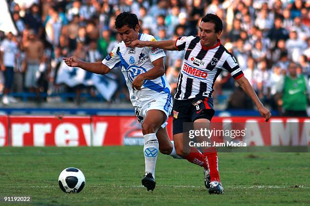 Luis Ernesto Perez of Monterrey vies for the ball with Manuel Lopez of Puebla during their match in the 2009 Opening tournament, the closing stage of...