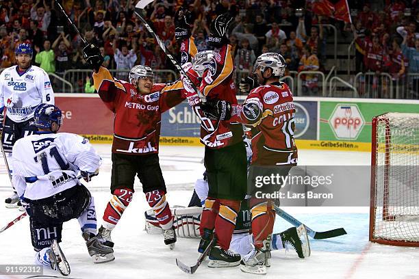 Patrick Reimer of Duesseldorf celebrates scoring his teams second goal with team mates Daniel Kreuzer and Rob Collins during the DEL match between...