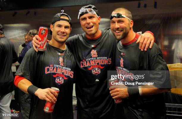 Skip Schumaker, Rick Ankiel and Mark DeRosa of the St. Louis Cardinals celebrate in the clubhouse after clinching the National League Central...