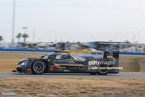 The Action Express Racing Cadillac DPi-V.R. Of Filipe Albuquerque, Joao Barbosa and Christian Fittipaldi races through a turn during the Rolex 24 at...