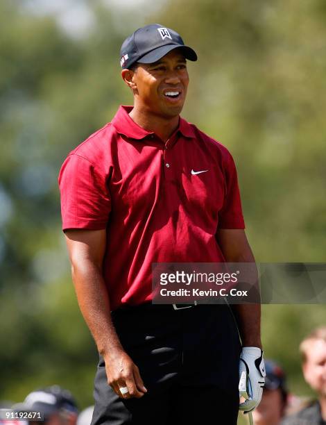 Tiger Woods reacts after teeing off the second hole into a sand trap during the final round of THE TOUR Championship presented by Coca-Cola, the...