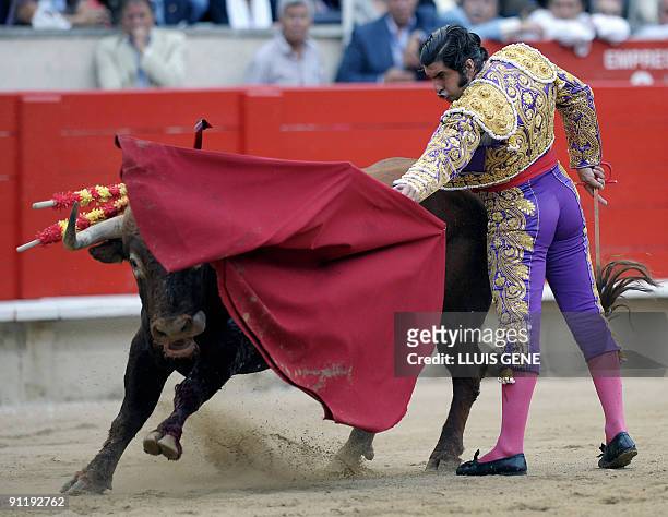 Spanish bullfighter Morante de la Puebla performs a pass on a bull at the Plaza Monumental bullring in Barcelona, on September 27, 2009. AFP...