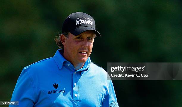 Phil Mickelson walks up the first hole during the final round of THE TOUR Championship presented by Coca-Cola, the final event of the PGA TOUR...