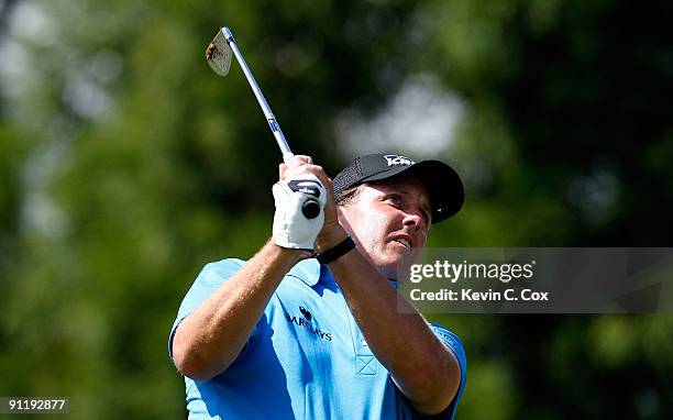 Phil Mickelson tees off the second hole during the final round of THE TOUR Championship presented by Coca-Cola, the final event of the PGA TOUR...