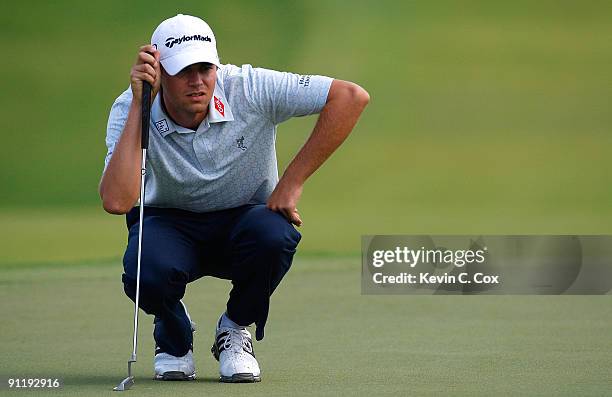Sean O'Hair lines up his birdie putt on the first green during the final round of THE TOUR Championship presented by Coca-Cola, the final event of...