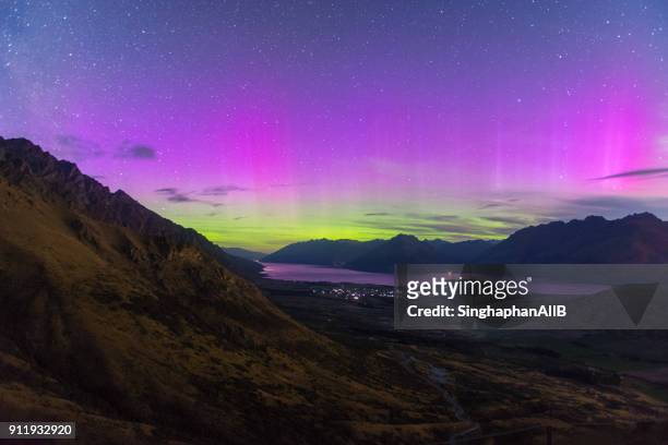 southern light in new zealand with the view of river, mountain and city lights, new zealand - aurora australis stock pictures, royalty-free photos & images