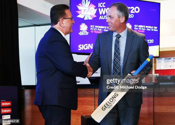 Minister John Eren accepts a cricket bat from Tony Dodemaide of Cricket Victoria during the ICC World T20 media opportunity at on January 30, 2018 in...