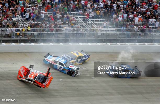 Joey Logano, driver of the Home Depot Toyota, flips his car after he was involved in a wreck with Reed Sorenson, driver of the Valvoline Dodge, Robby...