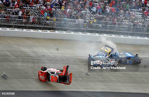 Joey Logano, driver of the Home Depot Toyota, flips his car after he was involved in a wreck with Reed Sorenson, driver of the Valvoline Dodge, Robby...