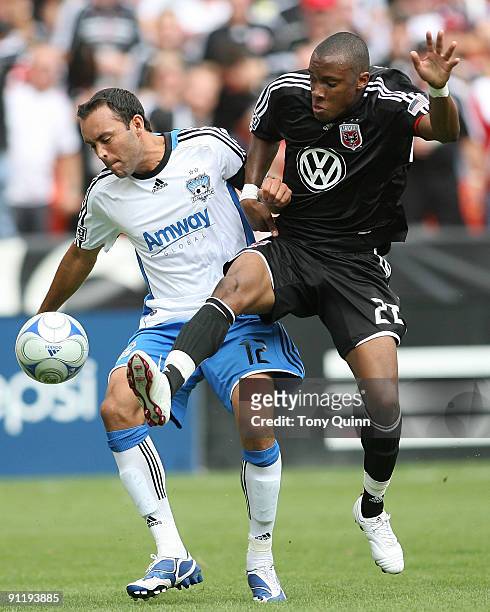 Rodney Wallace of D.C. United pokes the ball away from Ramiro Corrales of the San Jose Earthquakes during an MLS match at RFK Stadium on September...