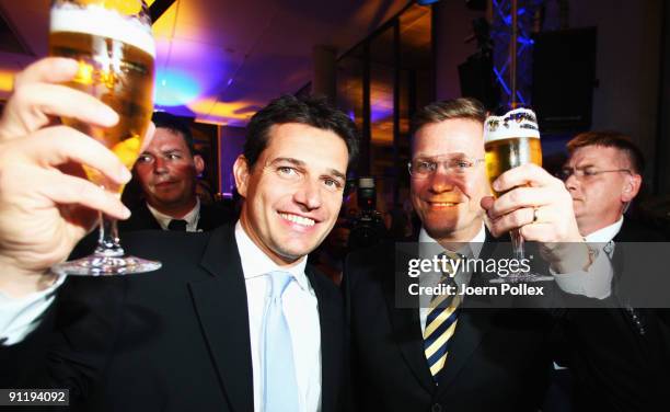 Guido Westerwelle, leader of Free Democratic Party , celebrates with his boyfriend Michael Mronz during the FDP election night party after reaching...