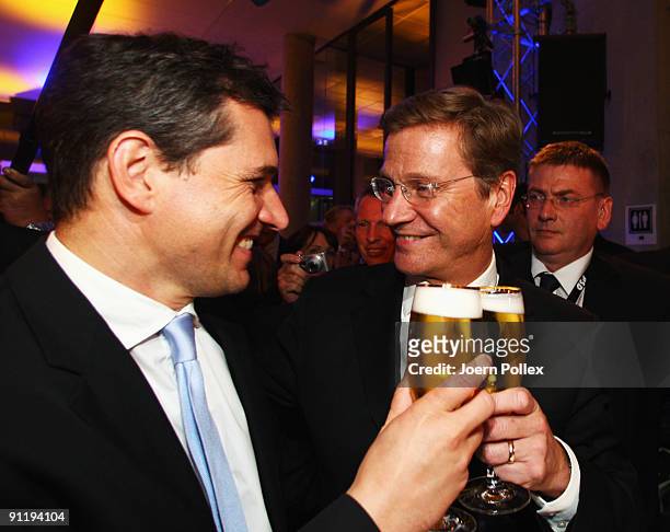 Guido Westerwelle, leader of Free Democratic Party , celebrates with his boyfriend Michael Mronz during the FDP election night party after reaching...