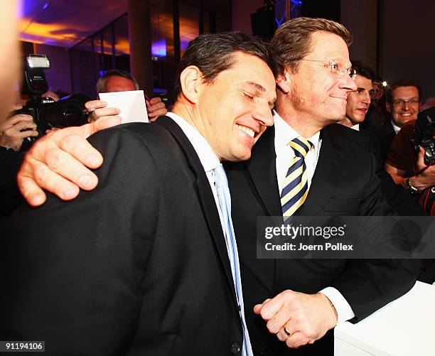 Guido Westerwelle, leader of Free Democratic Party , celebrates with his boyfriend Michael Mronz during the FDP election night party after reaching...