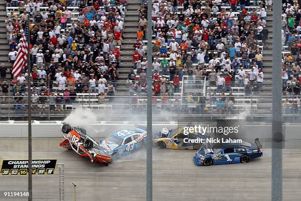 Joey Logano, driver of the Home Depot Toyota, flips his car after he was involved in a wreck with Reed Sorenson, driver of the Valvoline Dodge, Robby...