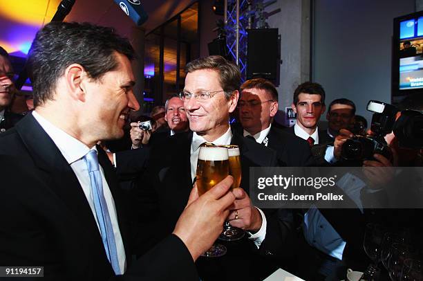 Guido Westerwelle, leader of Free Democratic Party , celebrates with his boyfriend Michael Mronz during the FDP election night party after reaching...