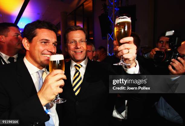 Guido Westerwelle, leader of Free Democratic Party , celebrates with his boyfriend Michael Mronz during the FDP election night party after reaching...