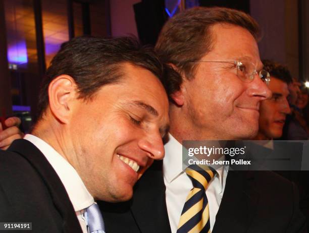 Guido Westerwelle, leader of Free Democratic Party , celebrates with his boyfriend Michael Mronz during the FDP election night party after reaching...