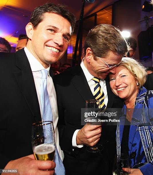 Guido Westerwelle, leader of Free Democratic Party , celebrates with his boyfriend Michael Mronz and Claudia Pieper during the FDP election night...
