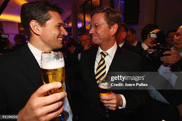 Guido Westerwelle, leader of Free Democratic Party , celebrates with his boyfriend Michael Mronz during the FDP election night party after reaching...