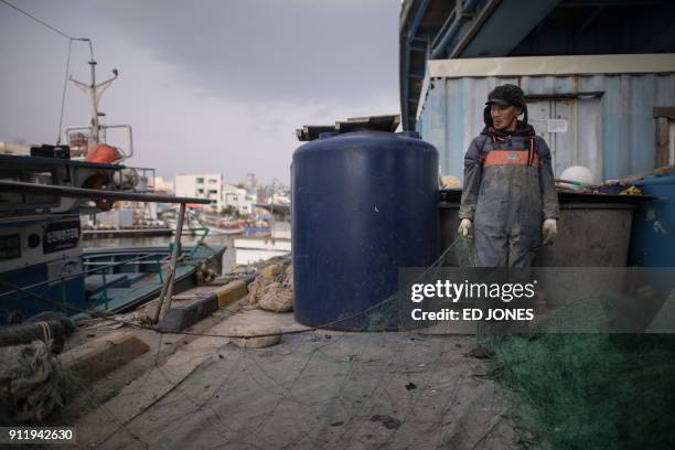 In a photo taken on January 16 Kim Gwang-Yong, born to North Korean refugees, hauls in fishing nets on a dock of "Abai village", a settlement made up...