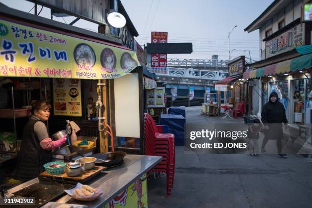 This photo taken on January 15, 2018 shows a food vendor in "Abai village", a village made up of North Korean refugees displaced during the 1950-53...