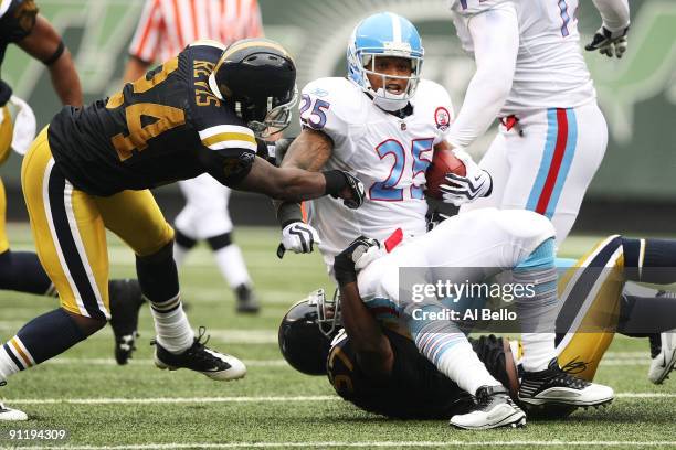 LenDale White of The Tennessee Titans is tackled by Darrelle Revis and Bart Scott of The New York Jets during their game on September 27, 2009 at...