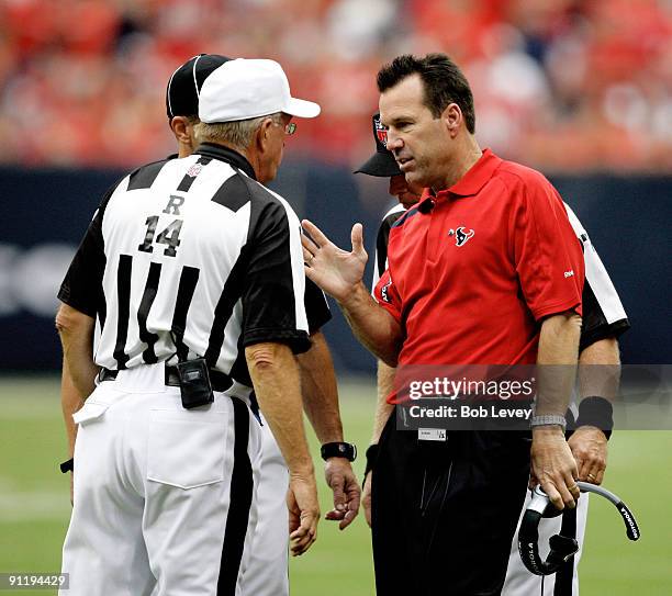 Head coach Gary Kubiak of the Houston Texans argues with referee Paul Winter about whether a fumble was correctly called at Reliant Stadium on...