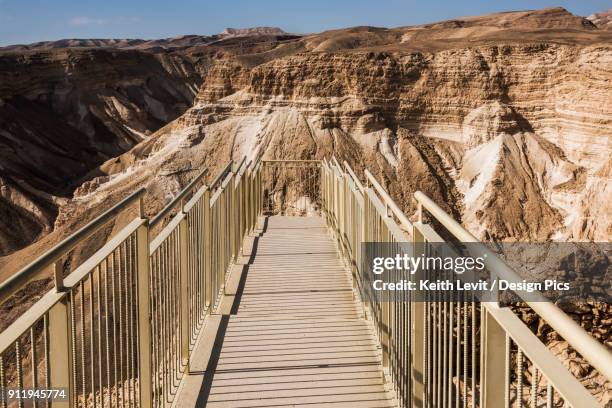 a walkway with railing to an outlook over masada and the judaean desert - judaean stock pictures, royalty-free photos & images