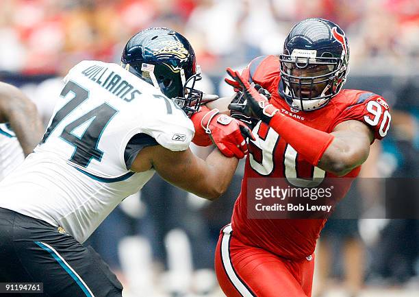 Defensive end Mario Williams of the Houston Texans battles with offensive tackle Maurice Williams of the Jacksonville Jaguars at Reliant Stadium on...