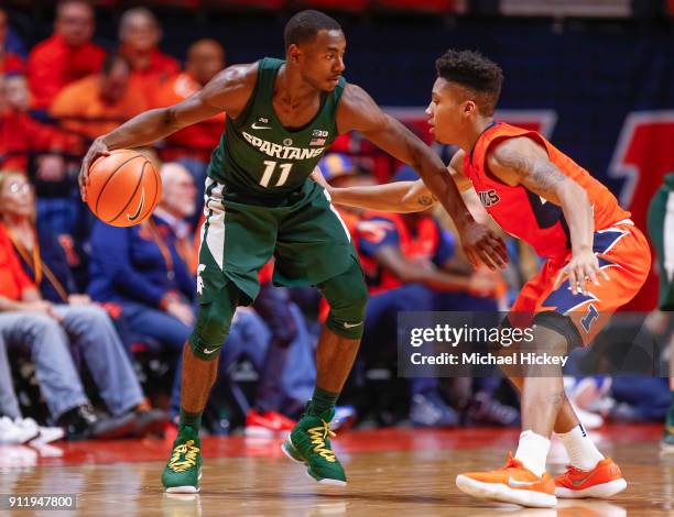 Lourawls Nairn Jr. #11 of the Michigan State Spartans dribbles the ball against Te'Jon Lucas of the Illinois Fighting Illini at State Farm Center on...