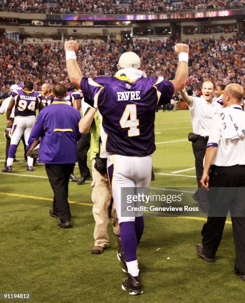 Quarterback Brett Favre of the Minnesota Vikings pumps his fists in celebration after defeating the San Francisco 49ers 27-24 at Hubert H. Humphrey...