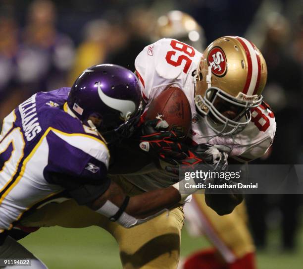 Vernon Davis of the San Francisco 49ers catches a touchdown pass as Madieu Williams of the Minnesota Vikings tries to defend at the Hubert H....