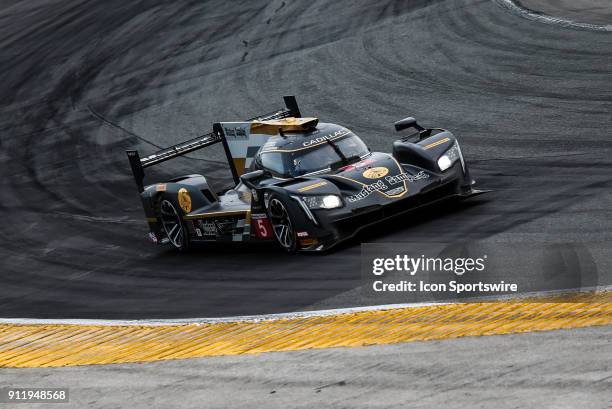 The Action Express Racing Cadillac DPi-V.R. Of Filipe Albuquerque, Joao Barbosa and Christian Fittipaldi races through a turn during the Rolex 24 at...