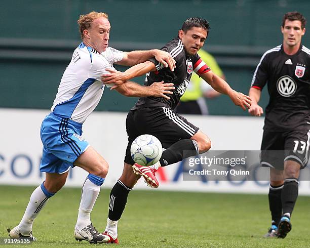 Jaime Moreno of D.C. United flicks the ball away from Simon Elliott of San Jose Earthquakes during an MLS match at RFK Stadium on September 27, 2009...