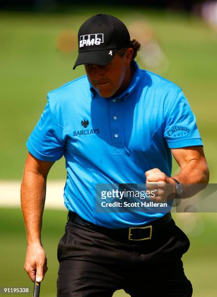 Phil Mickelson reacts after sinking a birdie putt on the fourth green during the final round of THE TOUR Championship presented by Coca-Cola, the...