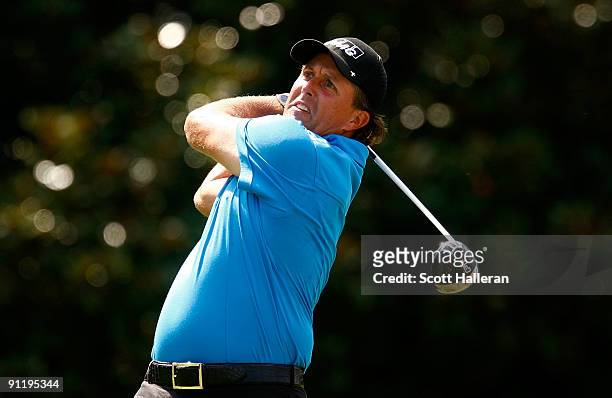 Phil Mickelson tees off the fifth hole during the final round of THE TOUR Championship presented by Coca-Cola, the final event of the PGA TOUR...