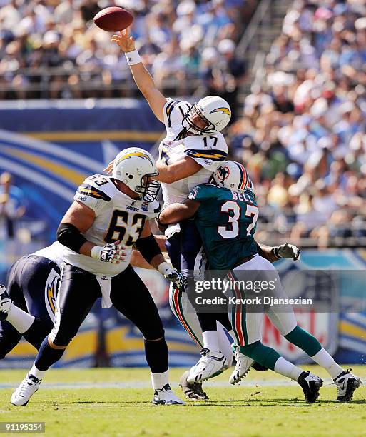 Philip Rivers of the San Diego Chargers is hit as he throws the ball incomplete by Yeremiah Bell of the Miami Dolphins during second quarter of the...