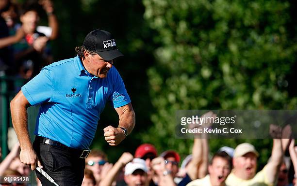 Phil Mickelson reacts after chipping in for birdie on the 16th green during the final round of THE TOUR Championship presented by Coca-Cola, the...