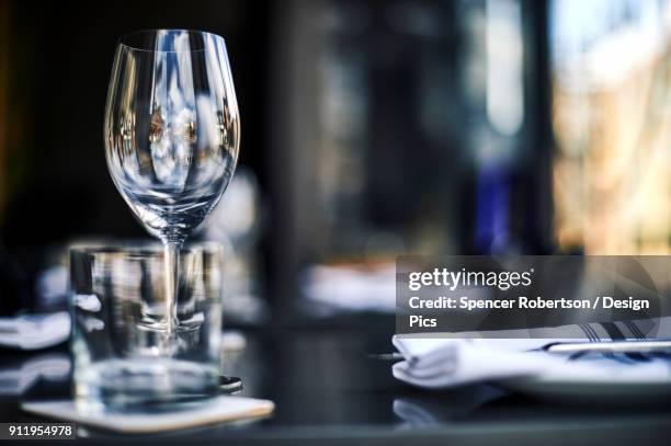 glass stemware and a formal place setting on a restaurant table - formal dining stock pictures, royalty-free photos & images