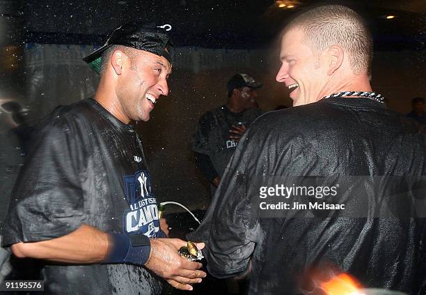 Derek Jeter and A.J. Burnett of the New York Yankees celebrate in the clubhouse after they defeated the Boston Red Sox on September 27, 2009 at...