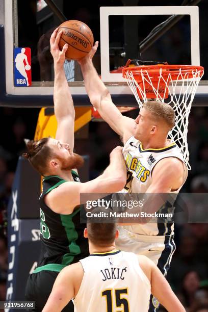 Aron Baynes of the Boston Celtics is rejected going to the basket by Mason Plumlee of the Denver Nuggets at the Pepsi Center on January 29, 2018 in...