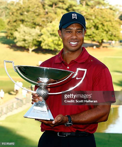 Tiger Woods poses with the 2009 FedExCup after the final round of THE TOUR Championship presented by Coca-Cola, the final event of the PGA TOUR...