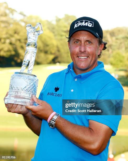 Phil Mickelson poses with the trophy after his three-stroke victory at THE TOUR Championship presented by Coca-Cola, the final event of the PGA TOUR...