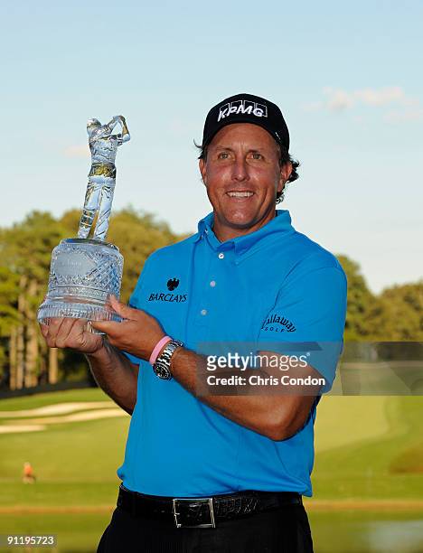 Phil Mickelson poses with the tournament trophy after winning THE TOUR Championship presented by Coca-Cola, the final event of the PGA TOUR Playoffs...